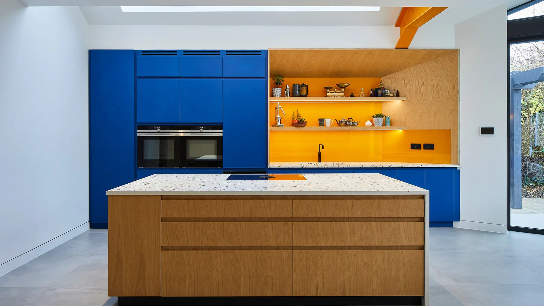 Blue and oak bespoke kitchen within the contemporary extension