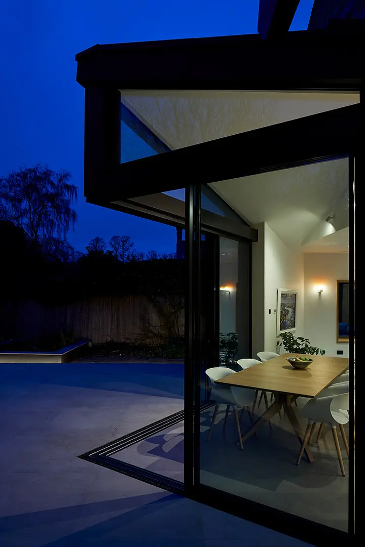 Glazed extension illuminated at dusk